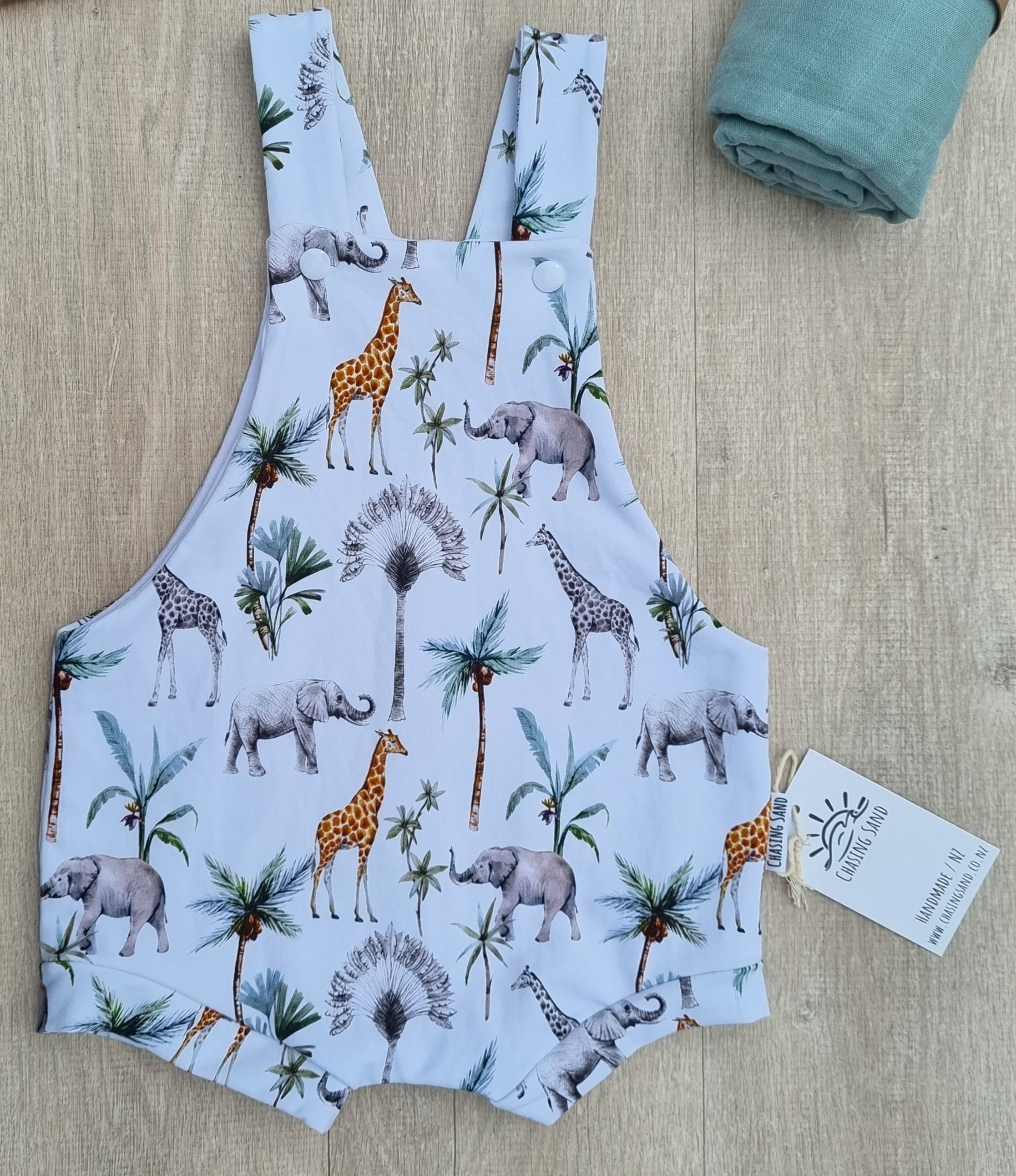 Shortie Overalls - Safari against wooden backdrop. African animal illustrations on white background.