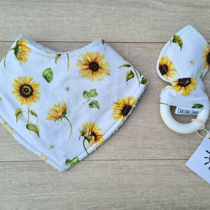 Dribble Bib - Sunflowers against wooden backdrop. Yellow sunflowers on white background.