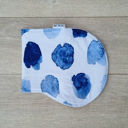 Burp Cloth - Watercolour against wooden backdrop. Blue watercolour patches on white background.