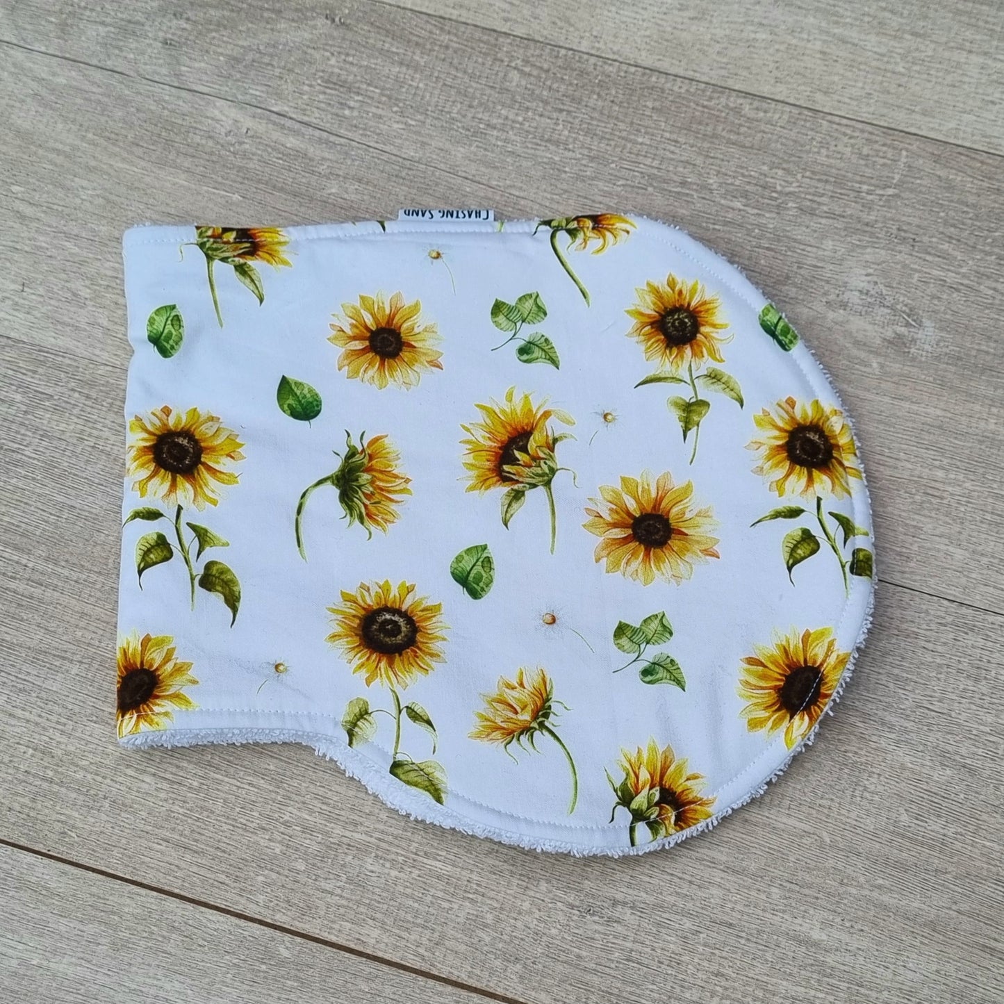 Burp Cloth - Sunflowers against wooden backdrop. Yellow sunflowers on white background.